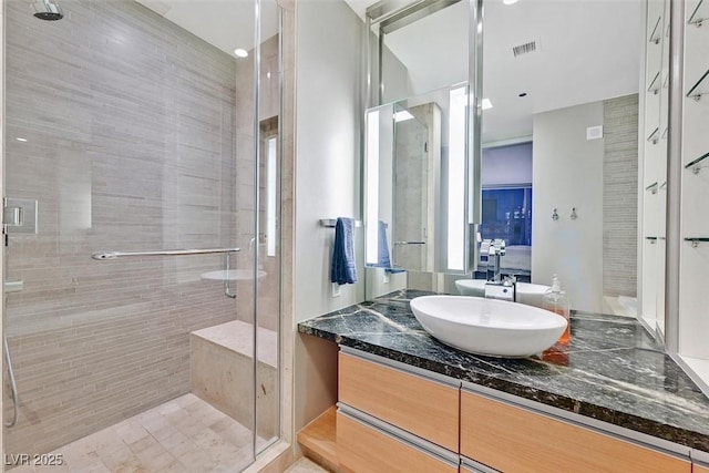 bathroom featuring visible vents, a shower stall, and vanity