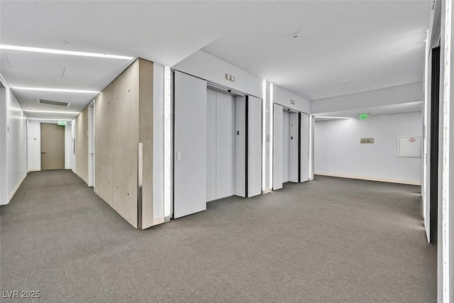 hall featuring carpet floors and elevator