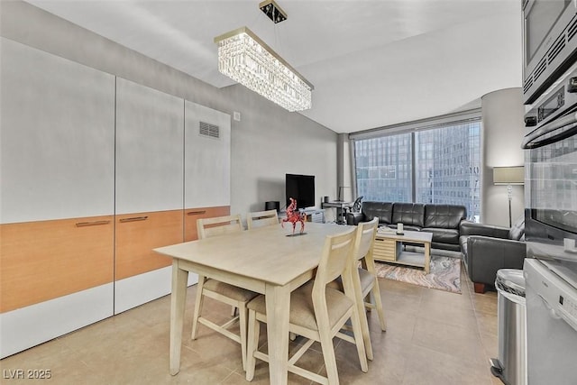 dining space with light tile patterned floors and visible vents