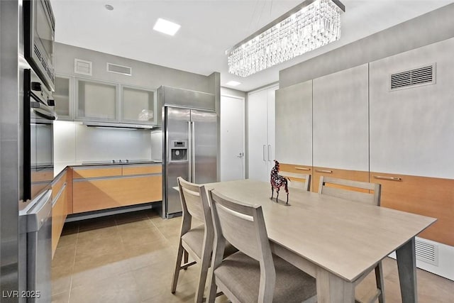 dining room with visible vents and light tile patterned floors