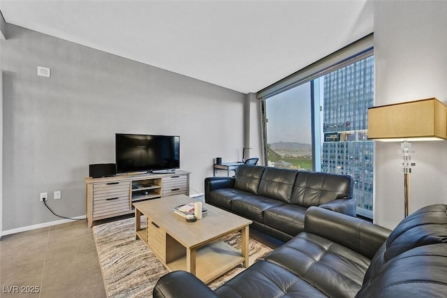 tiled living area featuring baseboards