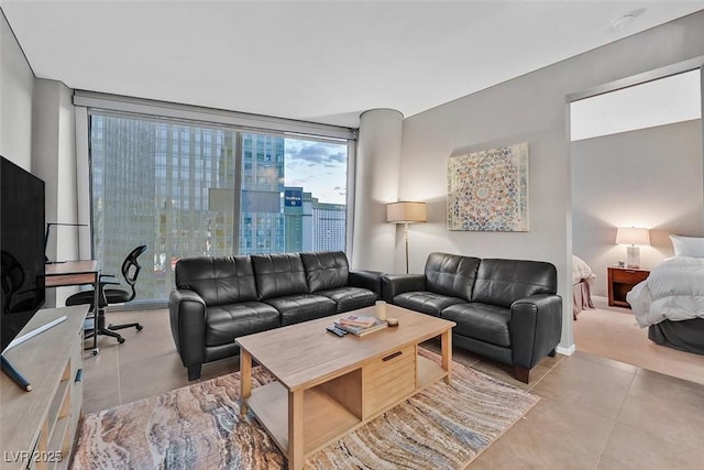 tiled living area with a wall of windows