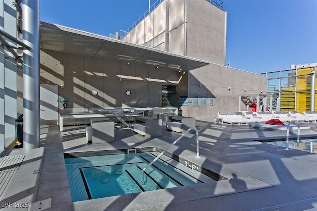 view of swimming pool featuring a community hot tub