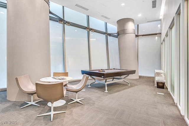 recreation room featuring carpet floors and floor to ceiling windows