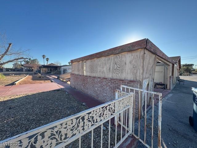 view of side of home with brick siding