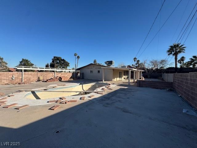 view of front facade with a fenced backyard and a patio