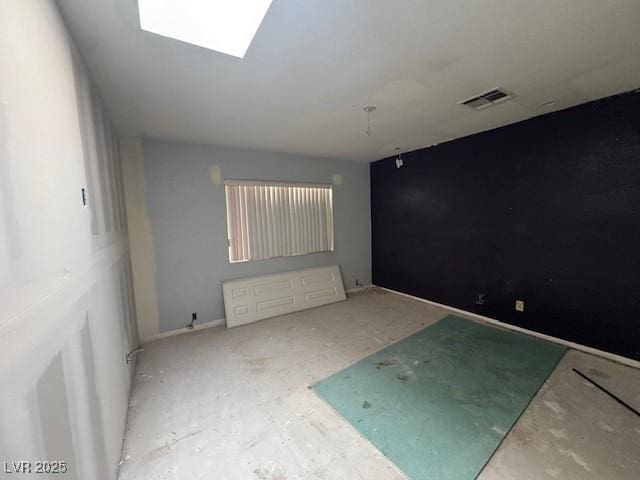 spare room with a skylight and visible vents