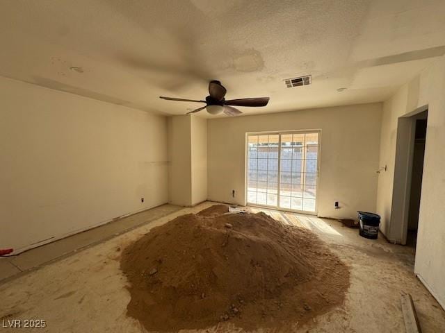 spare room with visible vents and a ceiling fan