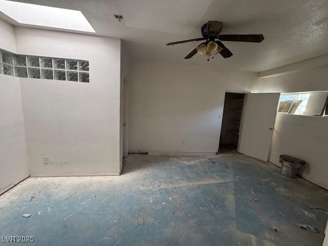 unfurnished bedroom featuring ceiling fan and a skylight