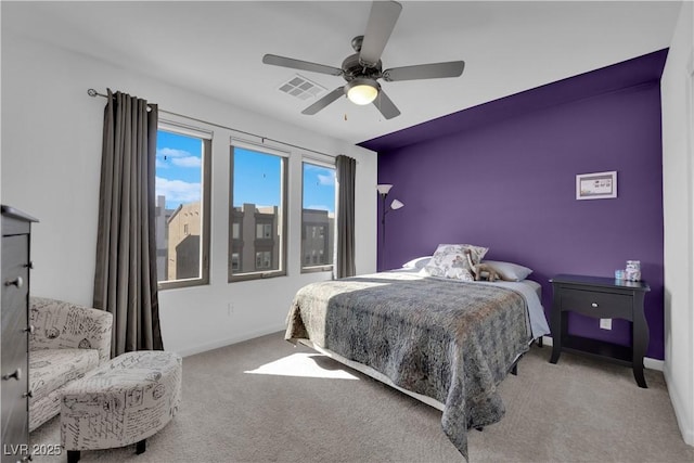 carpeted bedroom with ceiling fan, visible vents, and baseboards