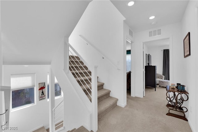 stairway featuring carpet flooring, visible vents, and recessed lighting