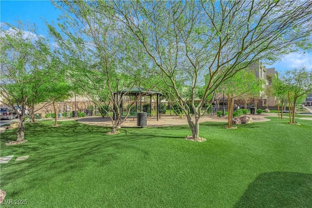 view of property's community with a lawn and a gazebo