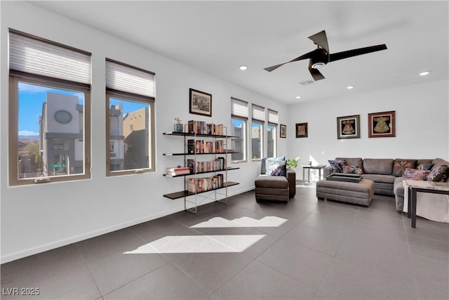 tiled living area featuring ceiling fan, baseboards, and recessed lighting