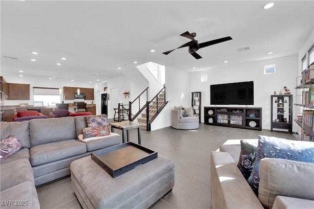 living area with ceiling fan, stairway, visible vents, and recessed lighting