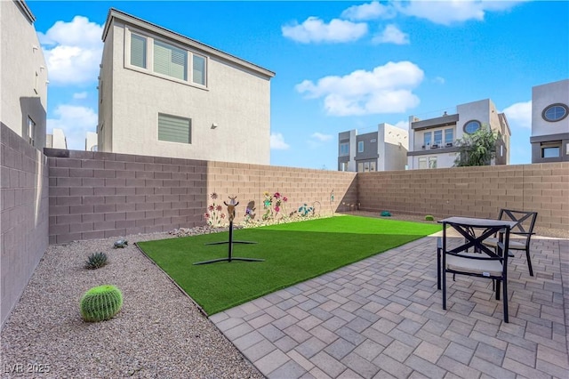 view of yard featuring a patio area and a fenced backyard