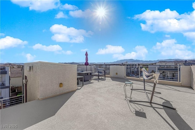 view of patio with a balcony and a mountain view