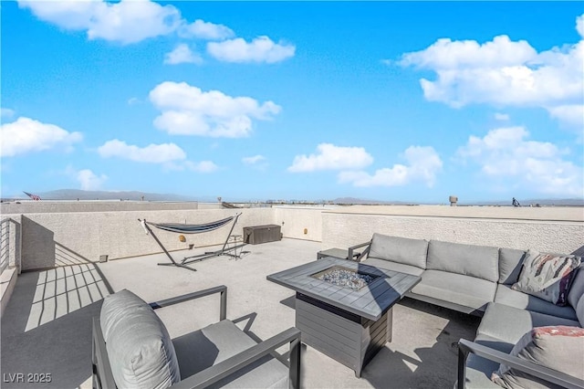 view of patio / terrace with an outdoor living space with a fire pit