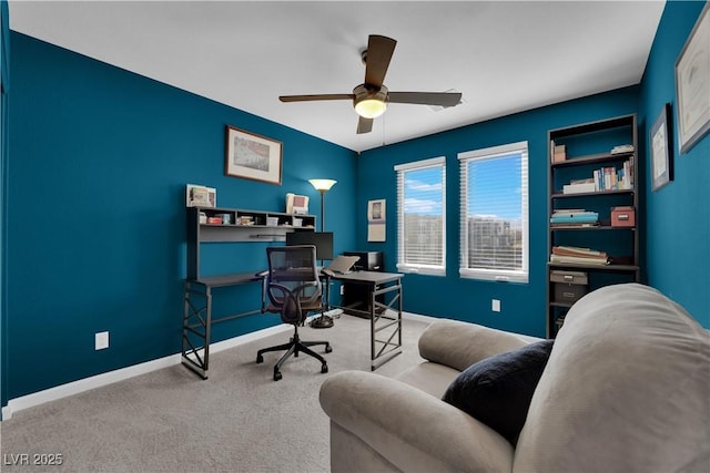 carpeted home office featuring ceiling fan and baseboards