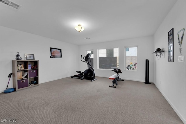 exercise room with baseboards, visible vents, and carpet flooring