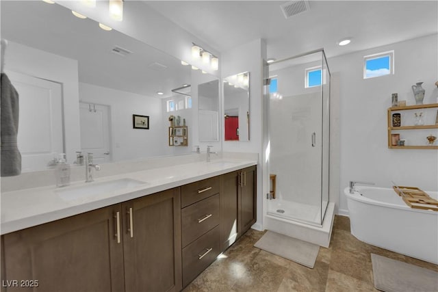 full bathroom with a shower stall, visible vents, and a sink