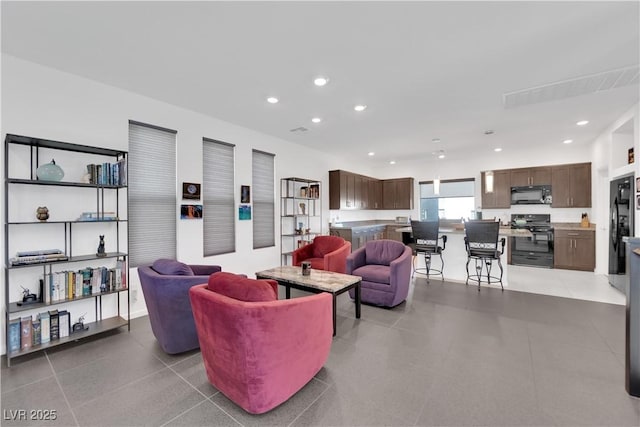 living room with light tile patterned floors and recessed lighting