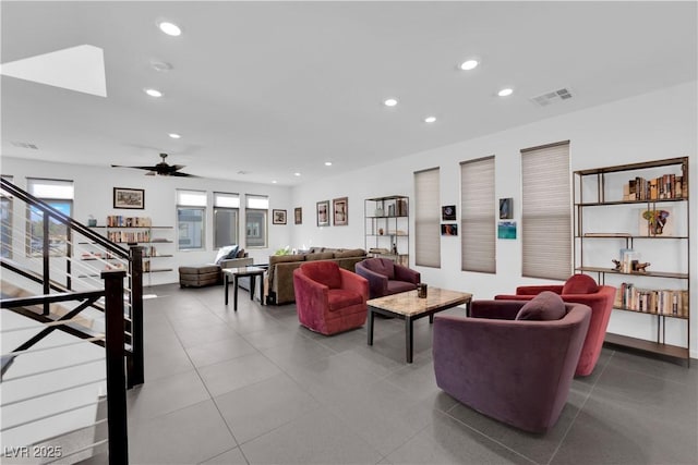 tiled living area with ceiling fan, stairs, visible vents, and recessed lighting