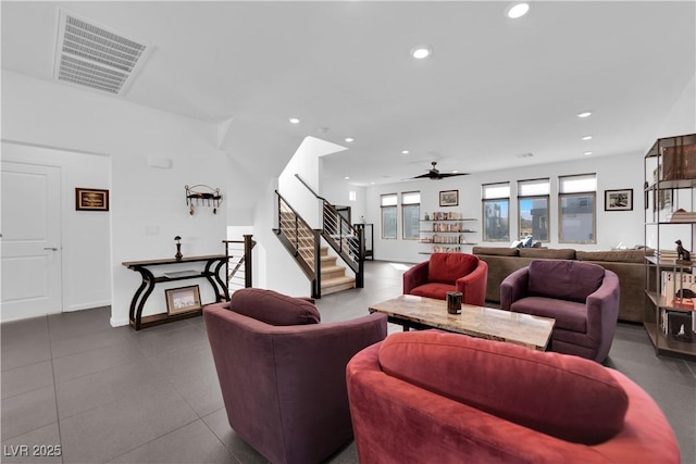 living area featuring ceiling fan, stairway, visible vents, and recessed lighting