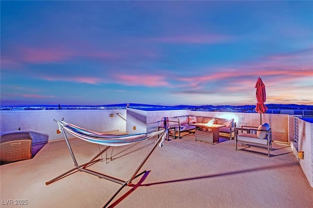 view of patio / terrace with a water view and an outdoor living space with a fire pit