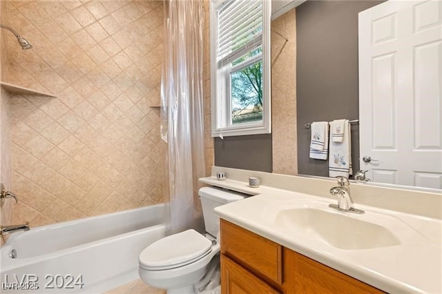 bathroom featuring vanity, shower / bath combination with curtain, and toilet