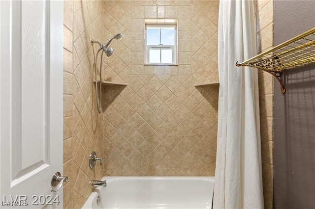 bathroom with shower / bath combo with shower curtain