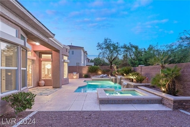 view of pool with an in ground hot tub, a patio area, a fenced backyard, and a fenced in pool