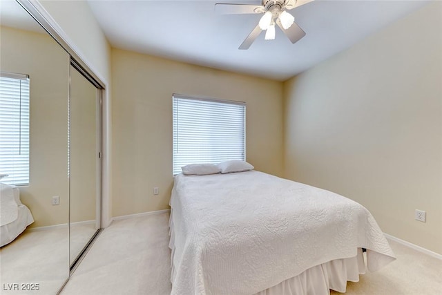 bedroom with multiple windows, a closet, and light colored carpet