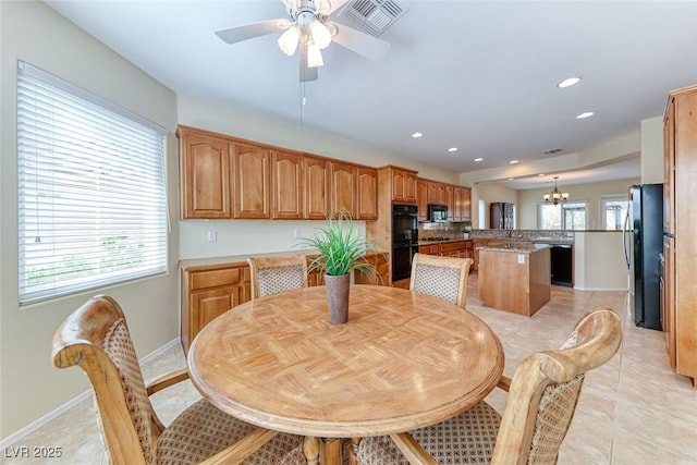 dining space featuring light tile patterned floors, recessed lighting, ceiling fan with notable chandelier, visible vents, and baseboards