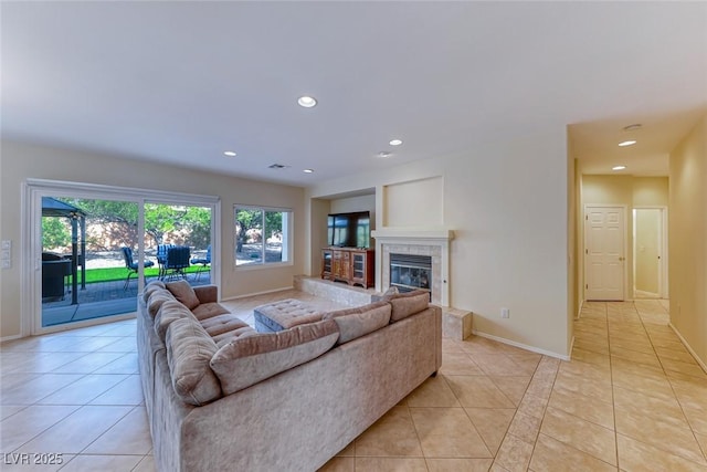 living room featuring recessed lighting, light tile patterned flooring, baseboards, and a tile fireplace