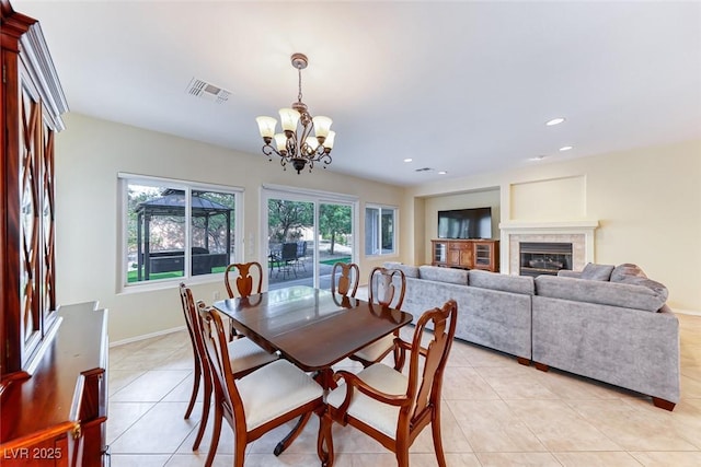 dining space featuring a healthy amount of sunlight, visible vents, and light tile patterned floors