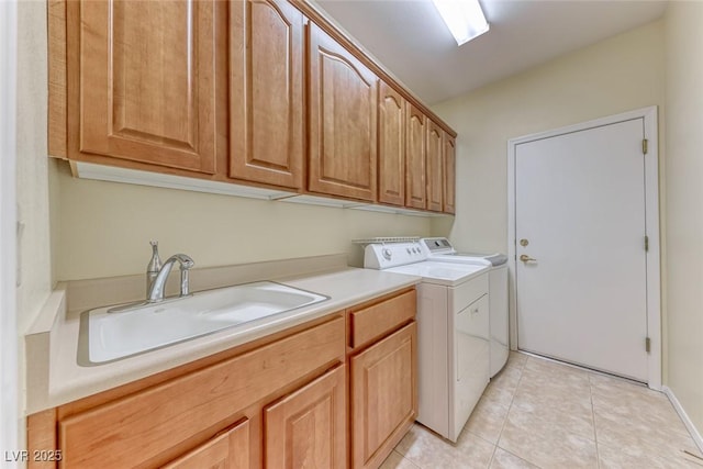 laundry room featuring light tile patterned flooring, a sink, cabinet space, and washer and dryer