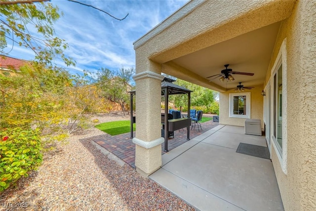 view of patio / terrace with a ceiling fan, outdoor lounge area, and a gazebo