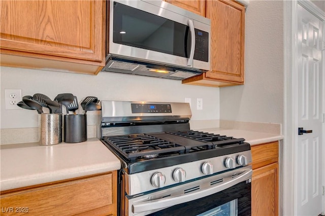 kitchen featuring appliances with stainless steel finishes and light countertops