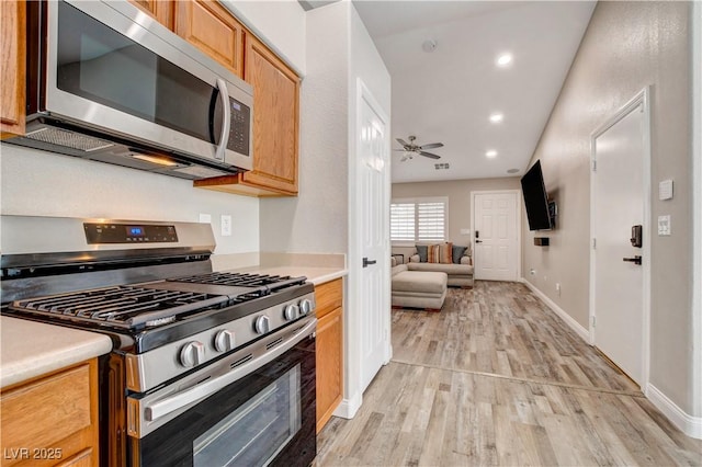 kitchen with ceiling fan, light wood-style flooring, recessed lighting, stainless steel appliances, and light countertops