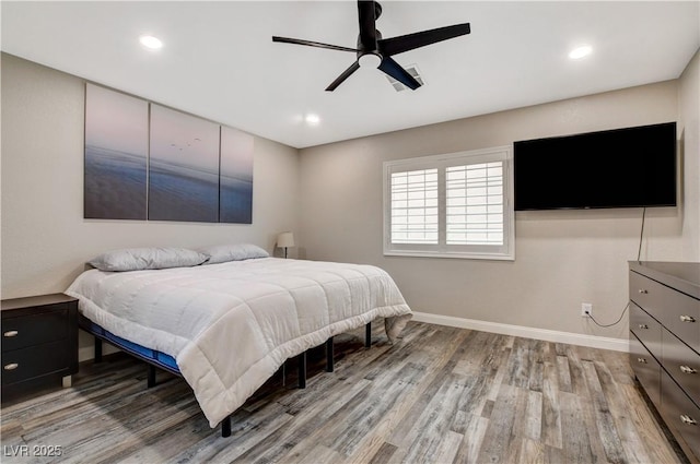 bedroom with light wood-type flooring, baseboards, and recessed lighting