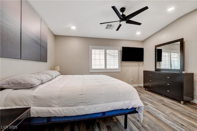 bedroom with light wood-type flooring, visible vents, and recessed lighting