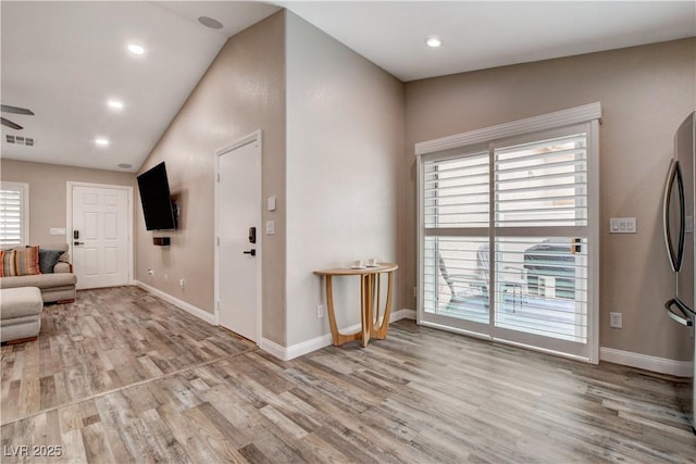 entryway with a ceiling fan, visible vents, baseboards, and wood finished floors