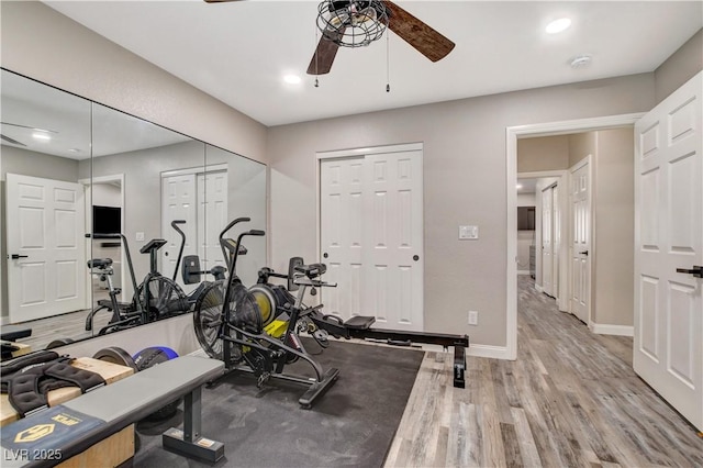 exercise room with ceiling fan, recessed lighting, light wood-type flooring, and baseboards