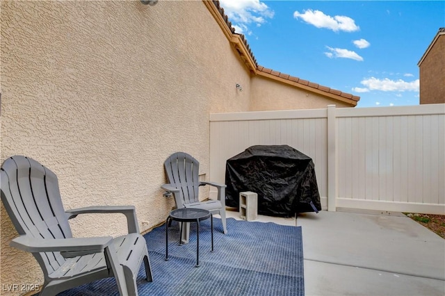 view of patio with fence and area for grilling