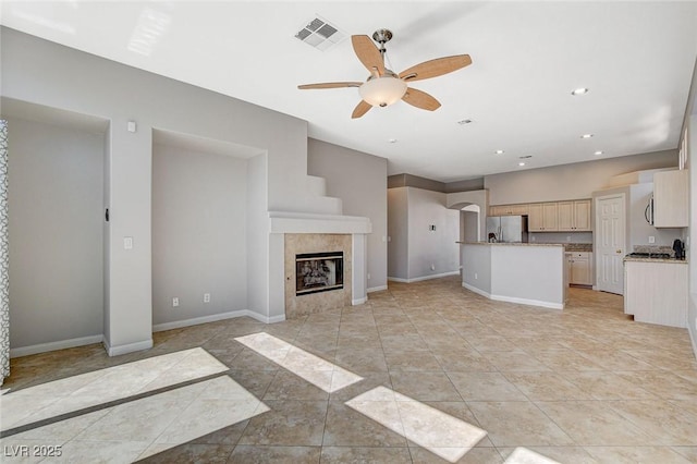 unfurnished living room featuring recessed lighting, visible vents, a fireplace, and baseboards