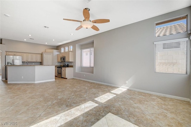 kitchen with stainless steel appliances, recessed lighting, light tile patterned flooring, and baseboards