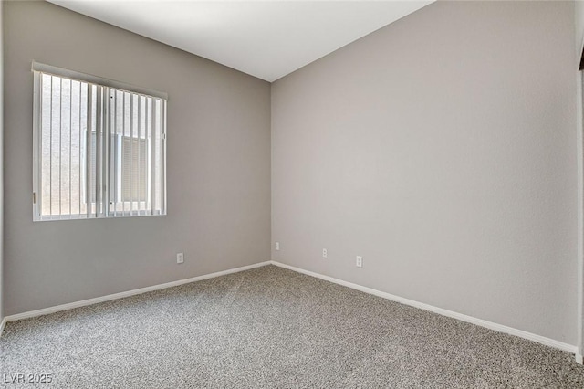 carpeted empty room with baseboards