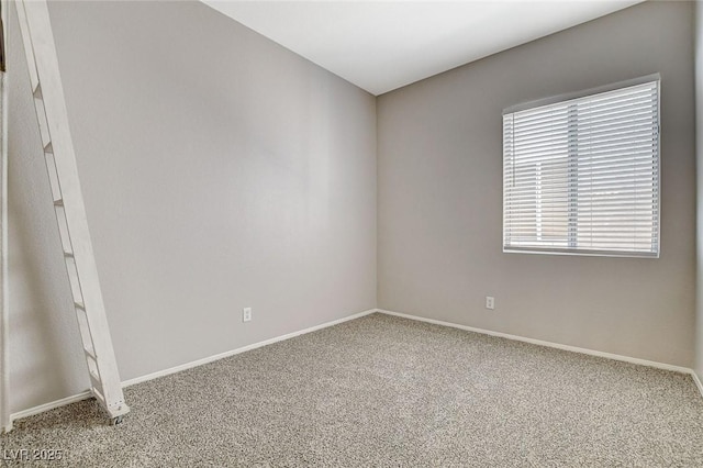 carpeted spare room with baseboards