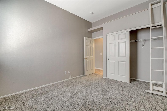 unfurnished bedroom with carpet, a closet, and baseboards