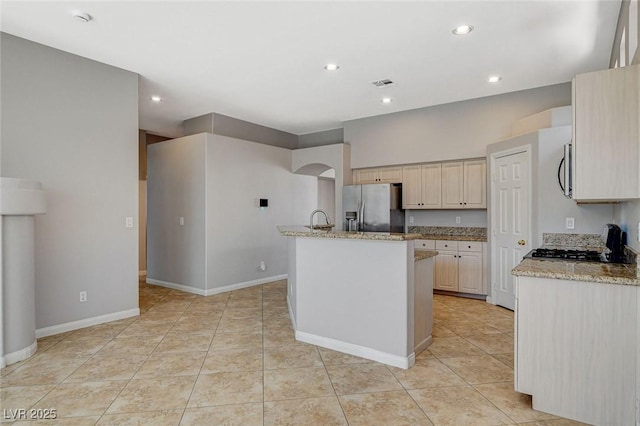 kitchen with light tile patterned floors, recessed lighting, visible vents, appliances with stainless steel finishes, and light stone countertops